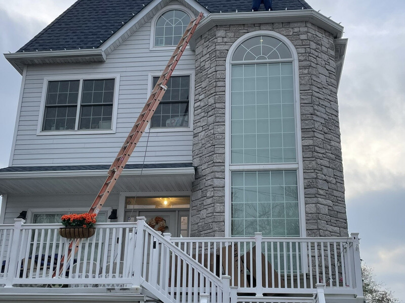 Holiday Lights Decor crew installing Christmas lights